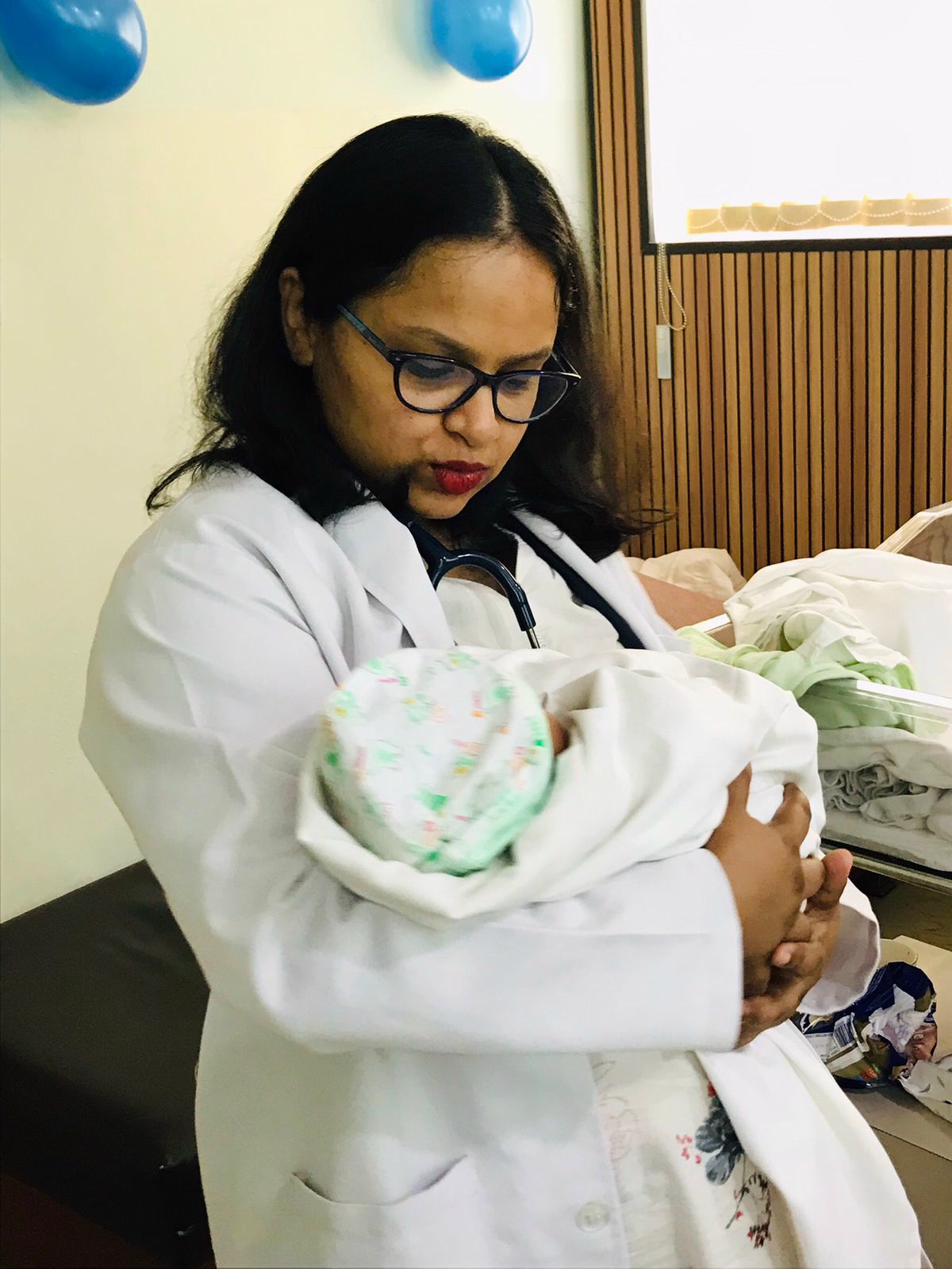 Dr. Anam Ghani holding newborn