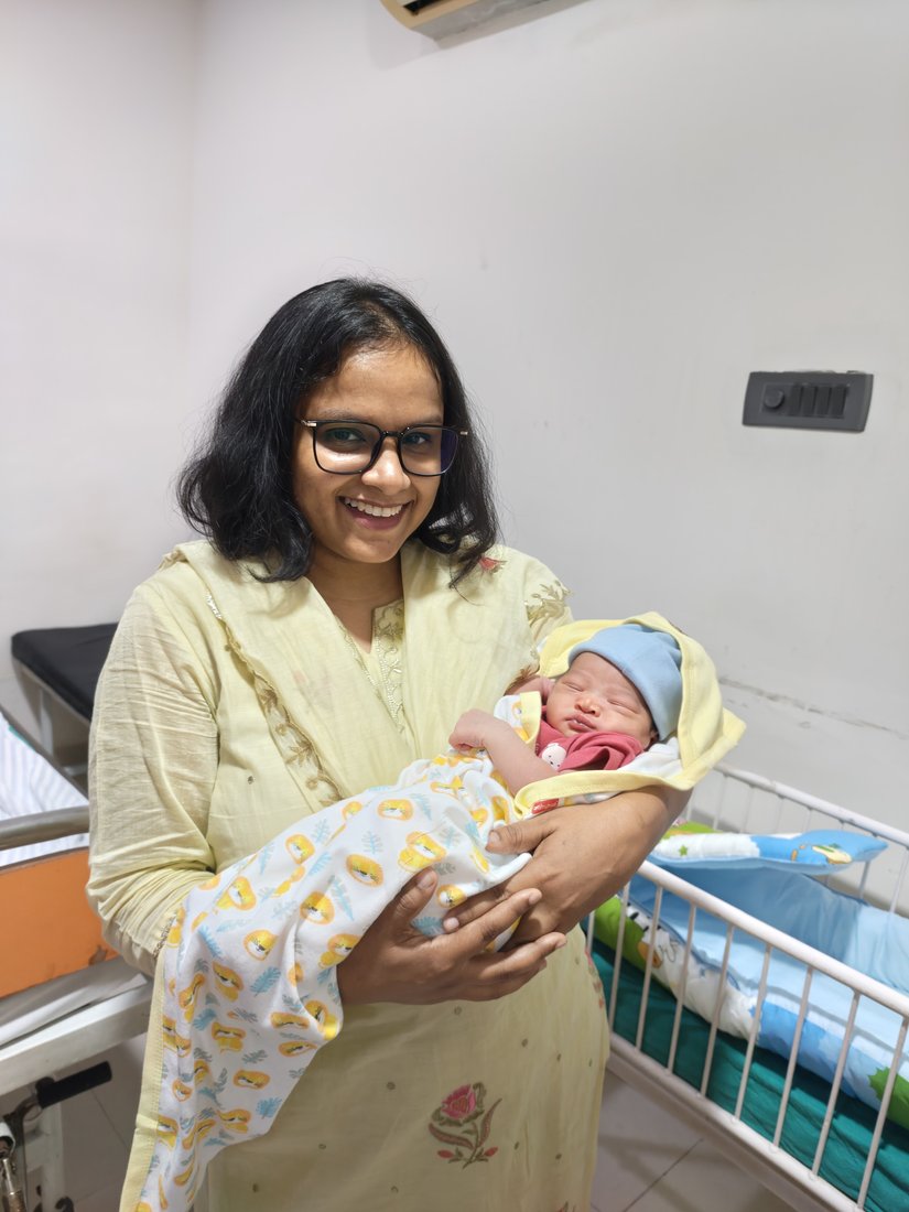 Dr. Anam Ghani holding a newborn baby at her Gurugram clinic