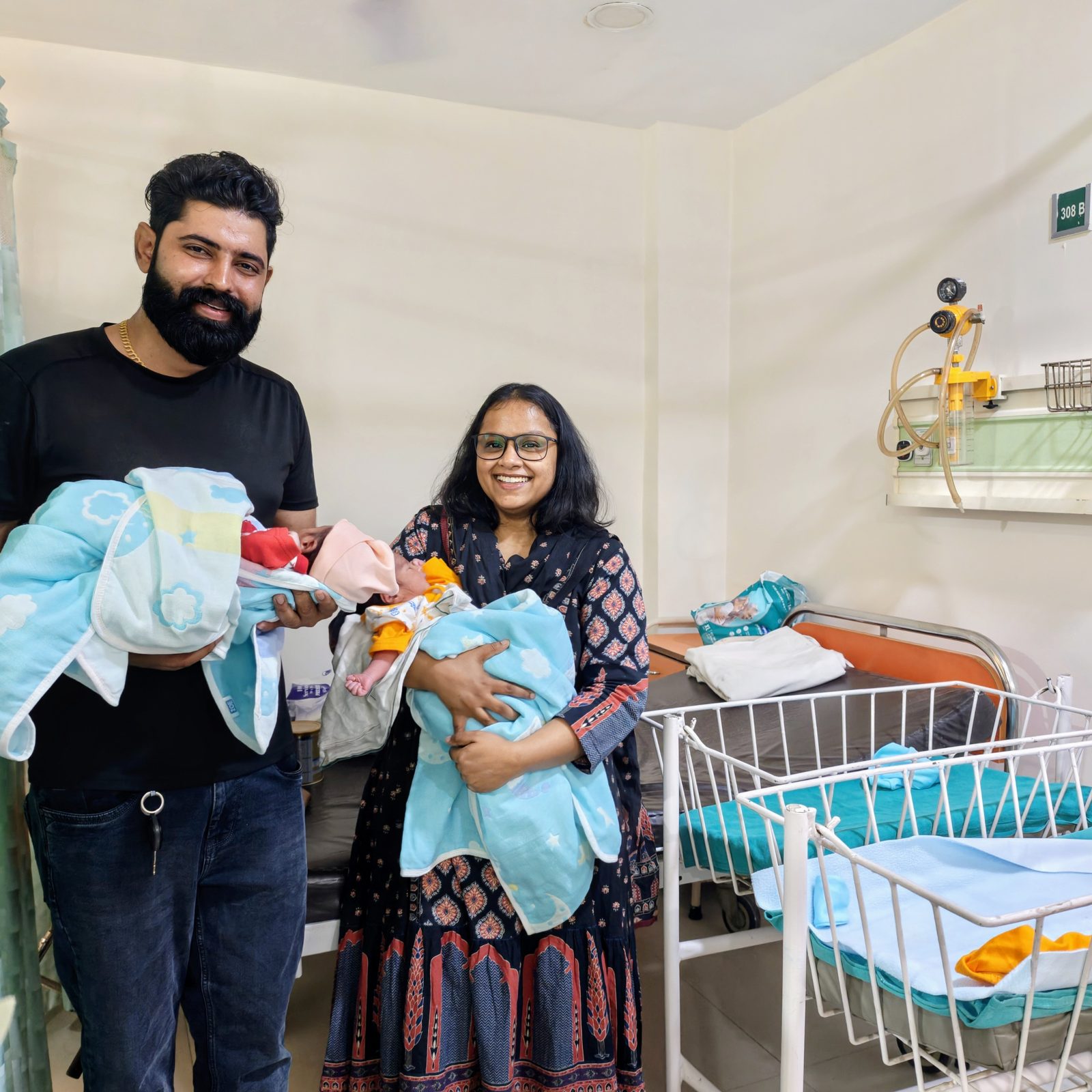 Proud parents with their twin babies