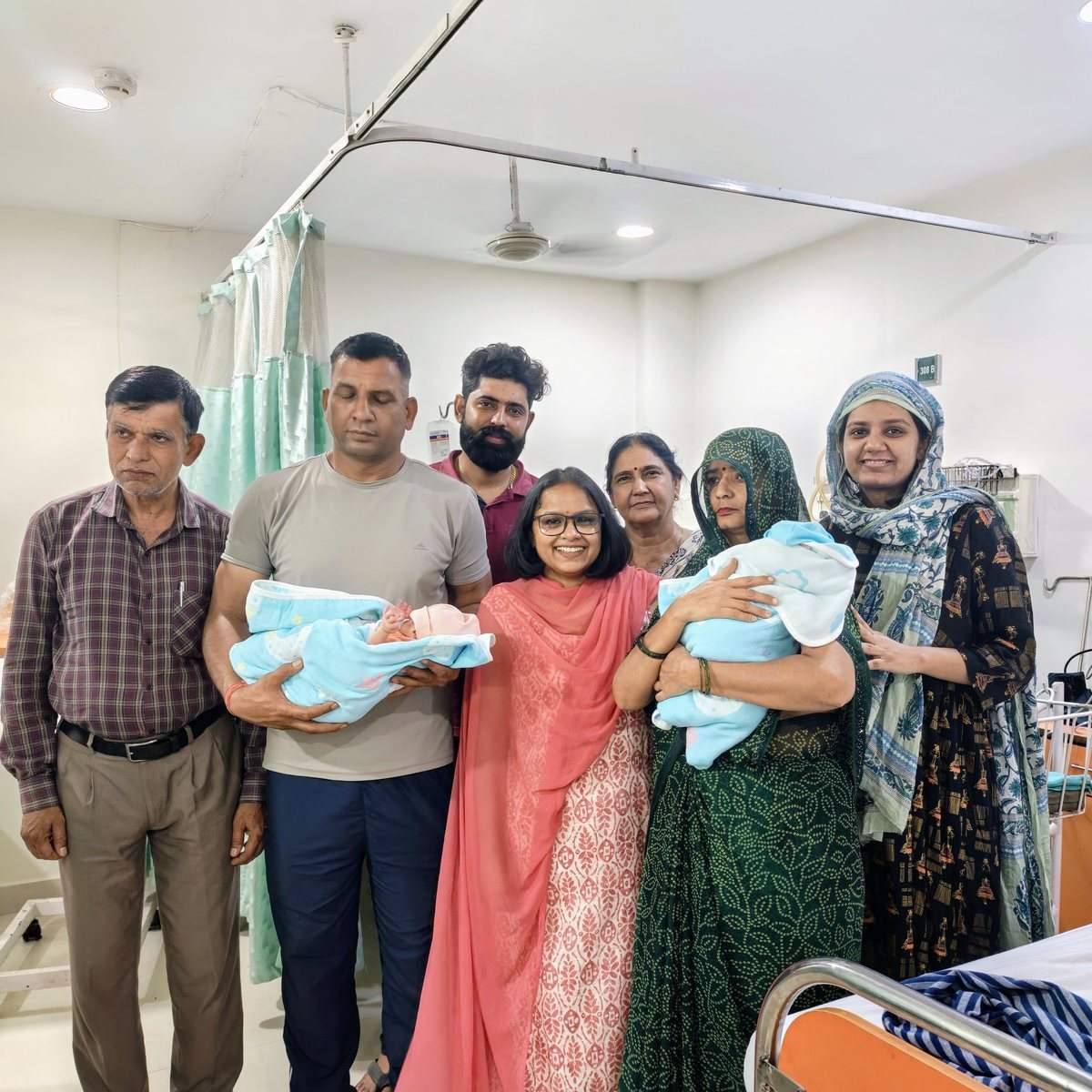 Dr. Anam Ghani with a family and their newborn twins after delivery in Gurugram
